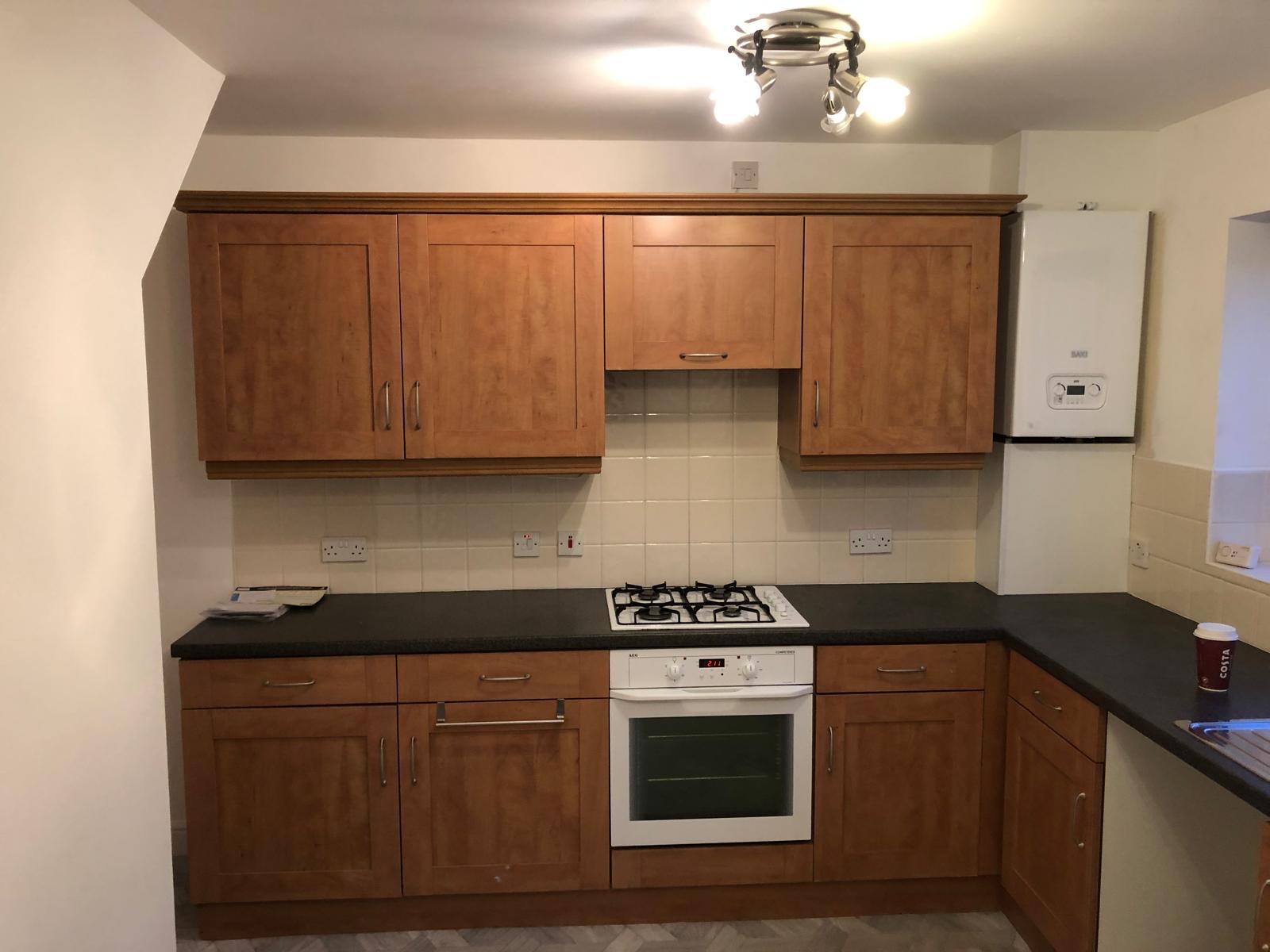 Cranbourne kitchen before the upgrade, with wood-effect cabinet doors